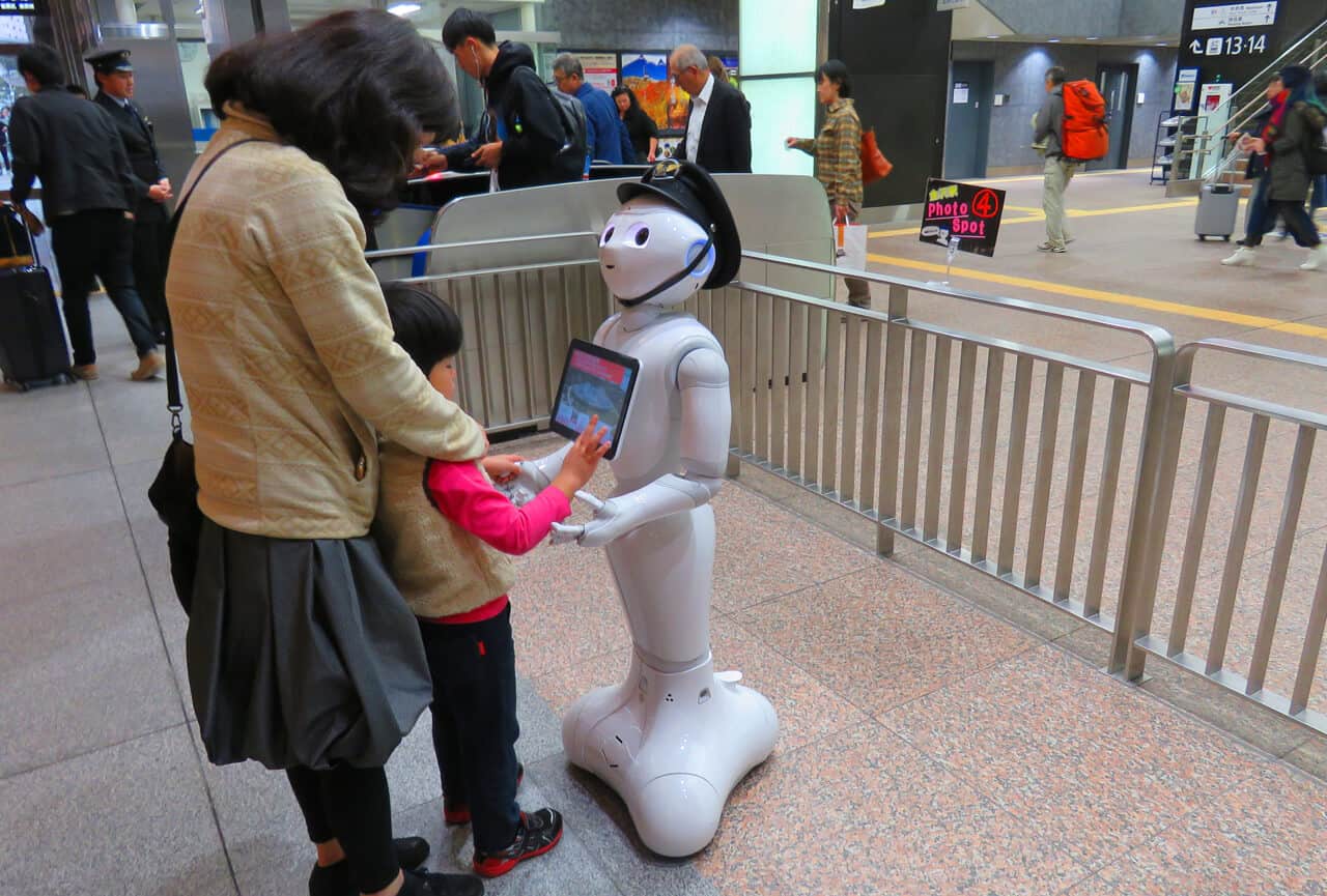 Robot and kid at main train station, Kanazawa