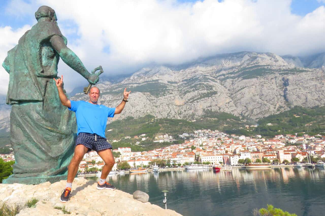 posing by the statue of St. Peter, Makarska