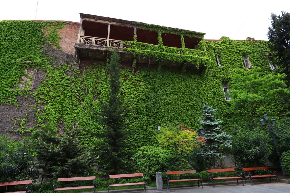 wooden balcony covered in moss, Tbilisi