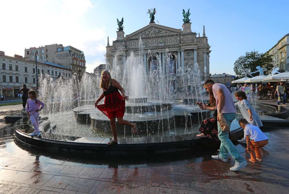 posing in front of the opera house in Lviv, Ukraine