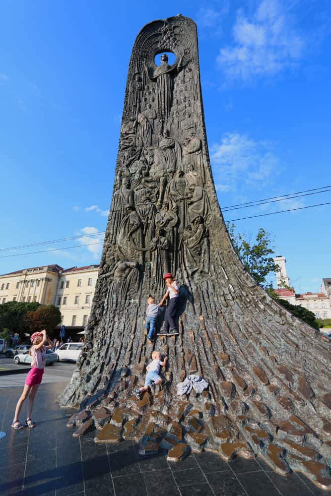 kids climbing the Taras Shevchenko Monument, Lviv. Why we loved our Summer in Lviv 